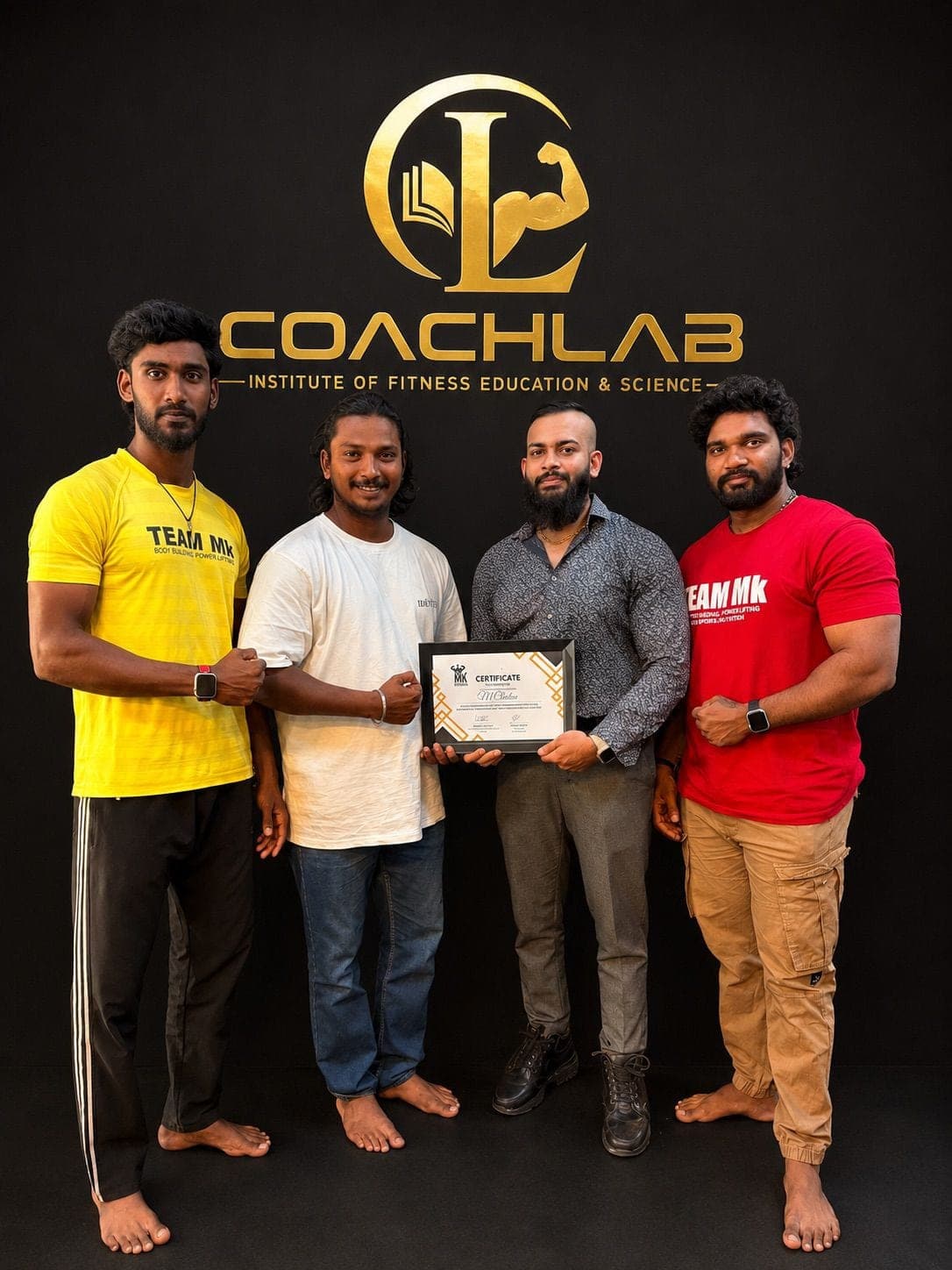 A CoachLab student holding a framed certificate with the instruction team.